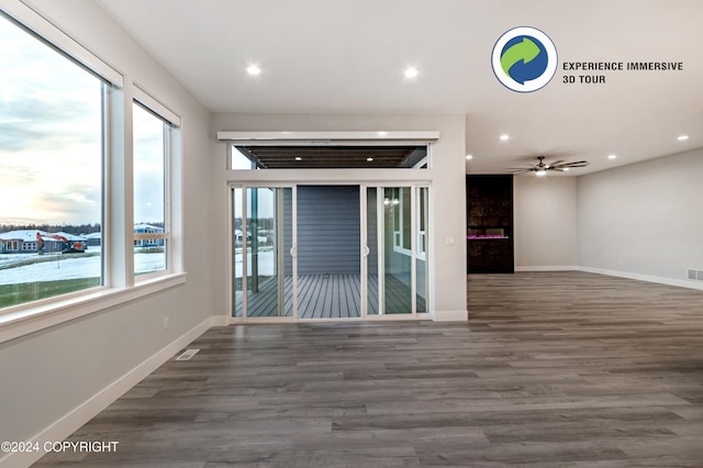 unfurnished room featuring dark wood-type flooring and ceiling fan