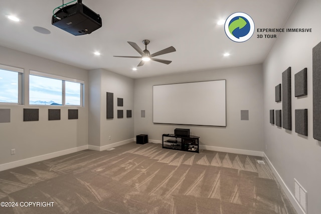 cinema room featuring carpet and ceiling fan