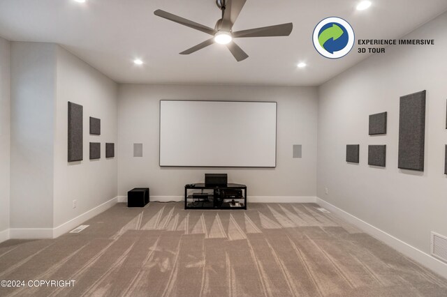 carpeted cinema room with ceiling fan