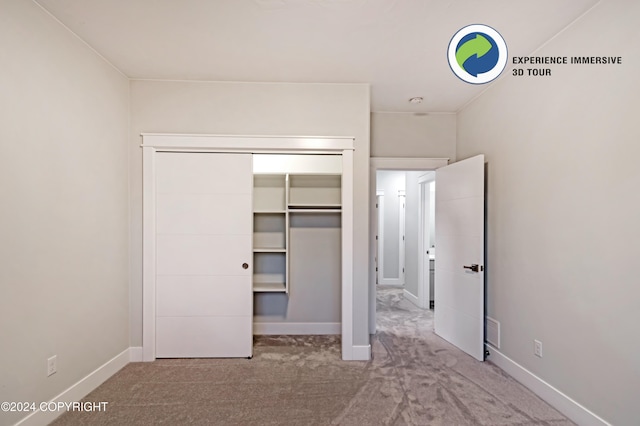 unfurnished bedroom featuring a closet and carpet floors