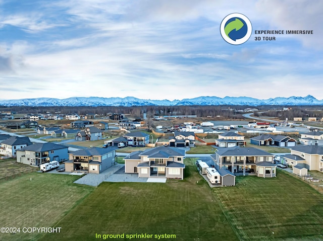 birds eye view of property with a mountain view