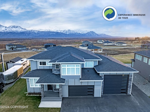 view of front of house featuring a mountain view and a garage