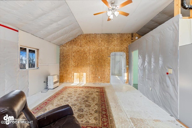 living room featuring ceiling fan and lofted ceiling