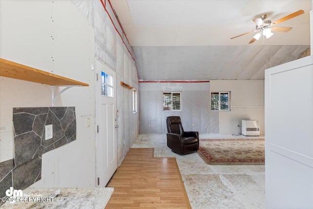 sitting room featuring lofted ceiling, light hardwood / wood-style flooring, and ceiling fan