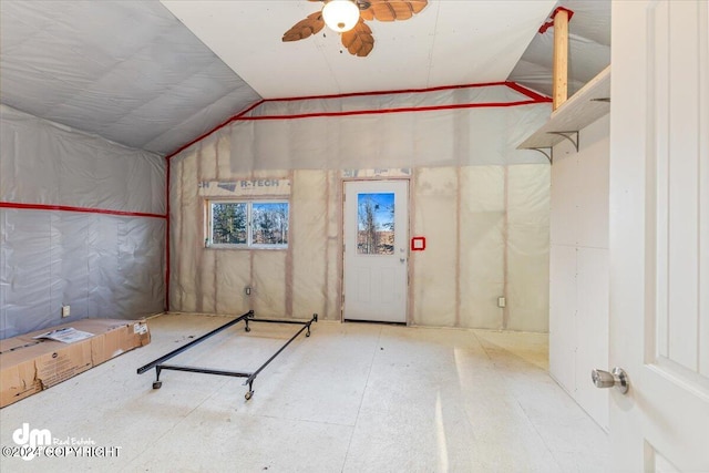 interior space with lofted ceiling and ceiling fan