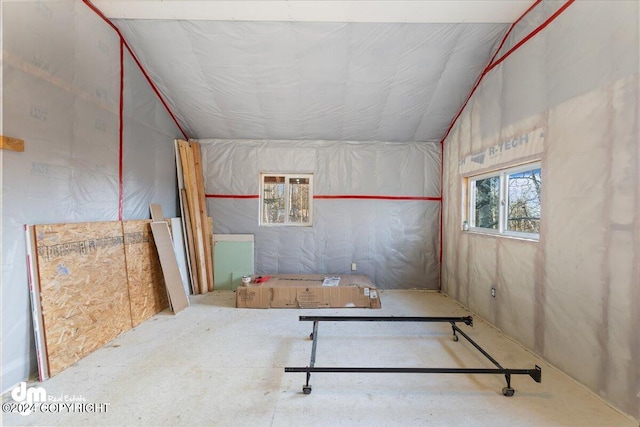 empty room featuring lofted ceiling