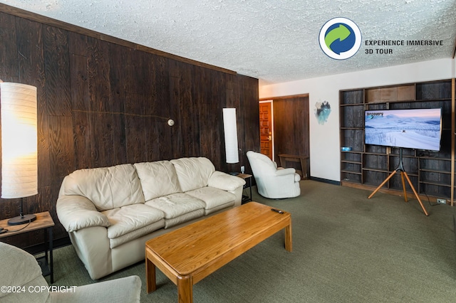 living room with carpet flooring, a textured ceiling, and wood walls