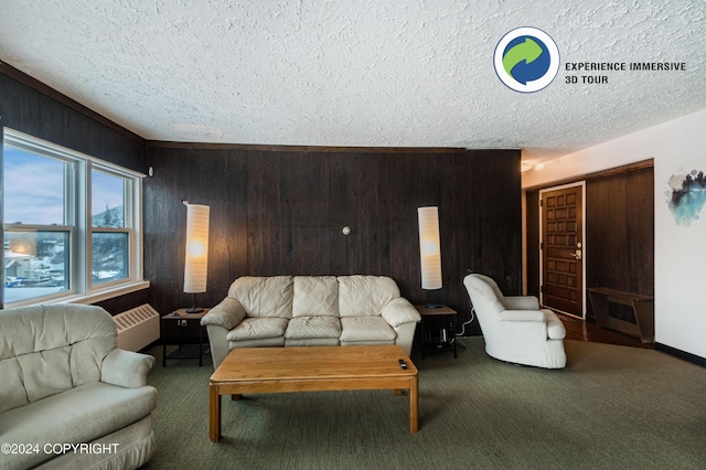 carpeted living room with a textured ceiling, a wall unit AC, and wooden walls