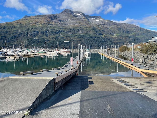 view of dock with a water and mountain view