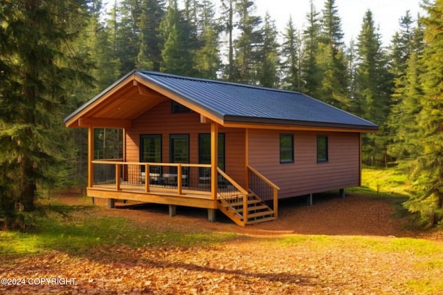 rear view of property featuring a deck