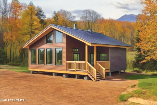 view of front of home with a mountain view and a front lawn