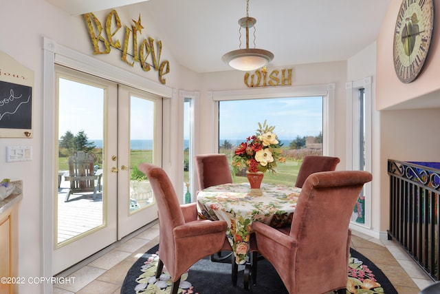 tiled dining area featuring french doors