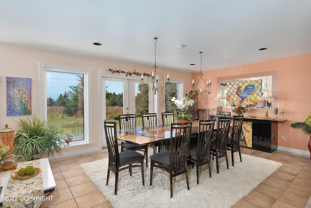 tiled dining room featuring french doors