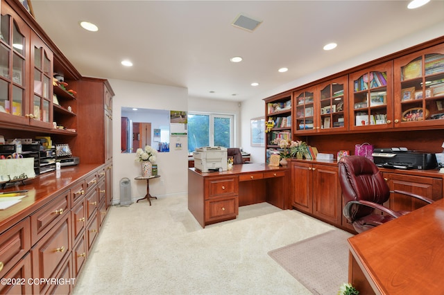 office with light carpet and built in desk