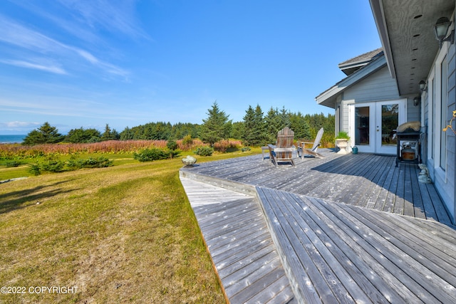 deck featuring french doors and a yard