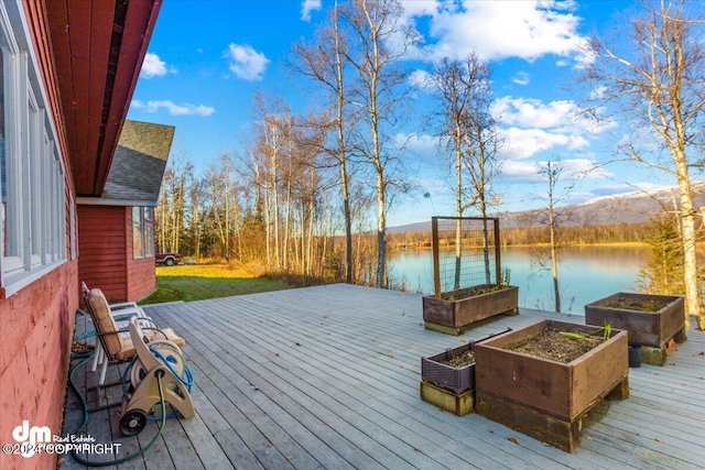 deck with a water and mountain view