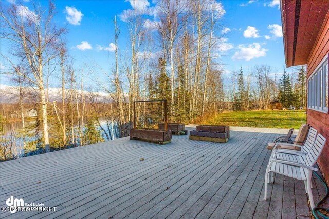 wooden terrace featuring a water view