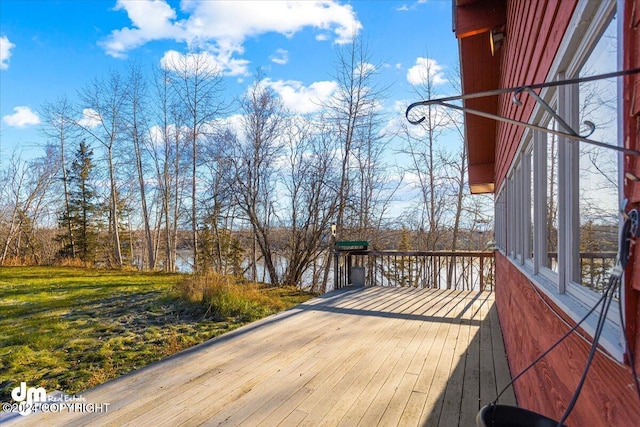 wooden terrace featuring a water view