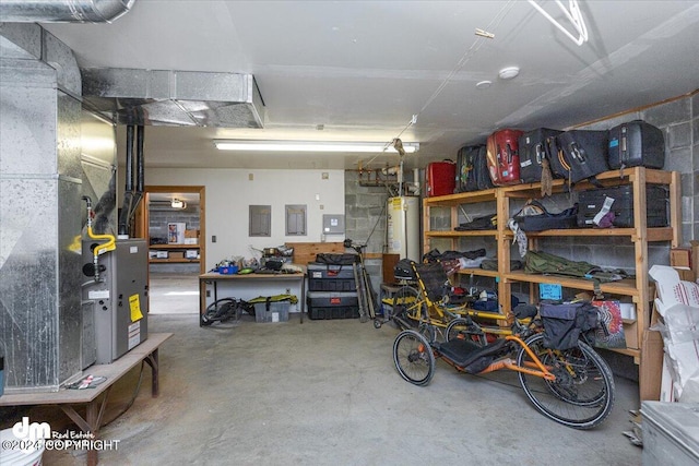 garage with a workshop area and water heater