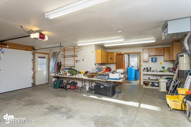 garage with a workshop area and a garage door opener