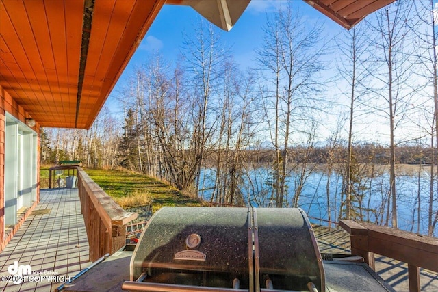 wooden deck featuring a water view