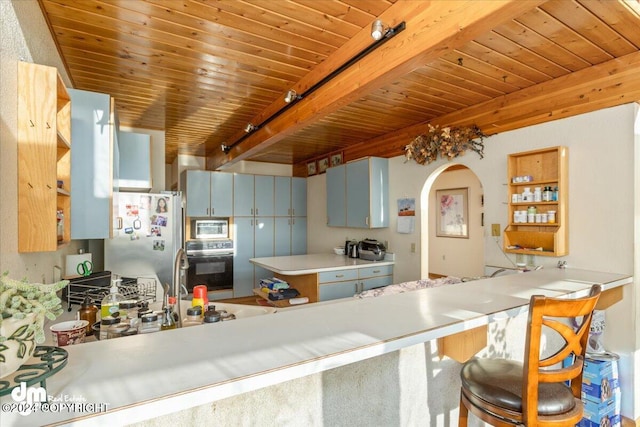 kitchen with blue cabinetry, kitchen peninsula, stainless steel appliances, and wood ceiling