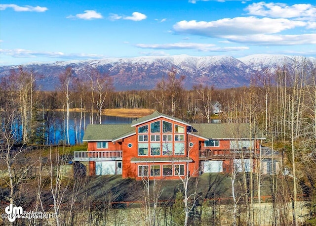 exterior space with a water and mountain view