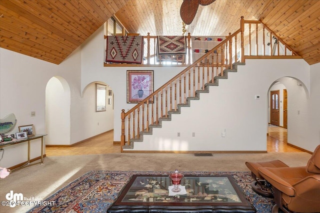 living room with carpet flooring, high vaulted ceiling, and wooden ceiling