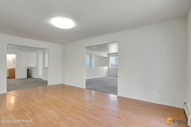 empty room with light hardwood / wood-style floors