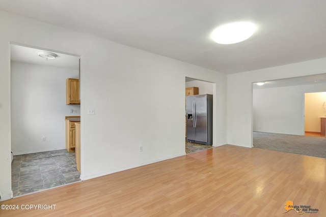 empty room with light hardwood / wood-style flooring