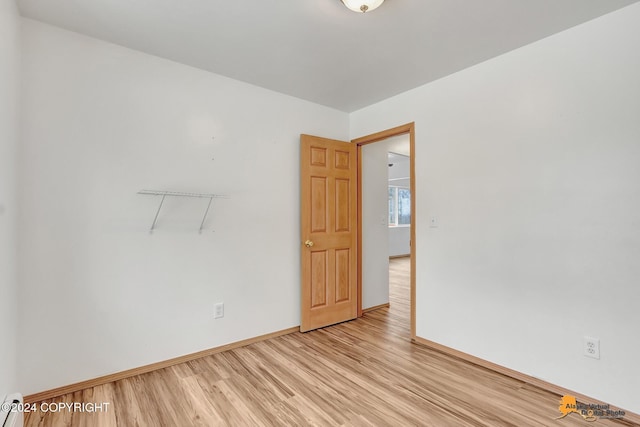 empty room with light hardwood / wood-style floors and baseboard heating