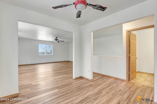 unfurnished living room featuring a baseboard heating unit, light wood-type flooring, and ceiling fan