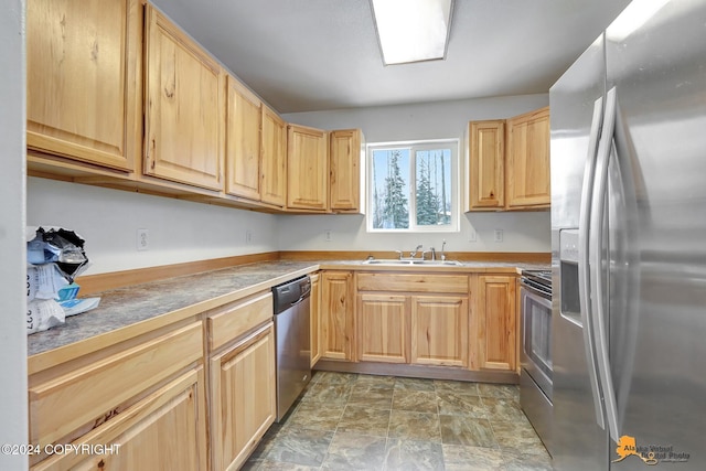 kitchen featuring light brown cabinets, stainless steel appliances, and sink