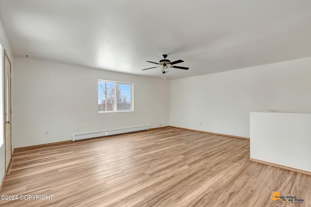 spare room with a baseboard radiator, light wood-type flooring, and ceiling fan