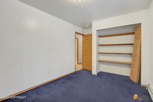 unfurnished bedroom with a closet, a baseboard radiator, and dark colored carpet