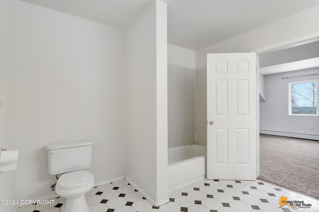 bathroom featuring a baseboard heating unit and toilet