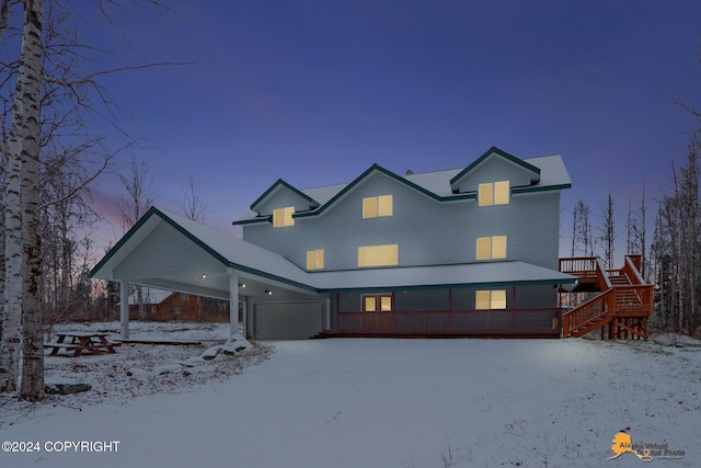 view of front of home with a deck and a carport