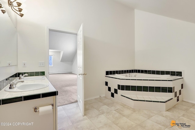 bathroom with vanity, tile patterned flooring, and tiled bath