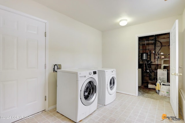 clothes washing area with separate washer and dryer