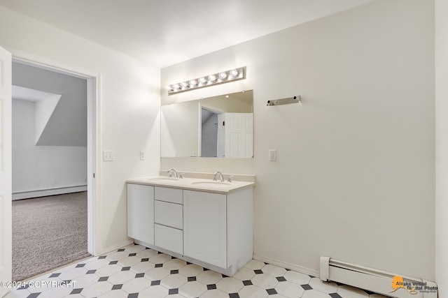 bathroom featuring baseboard heating and vanity