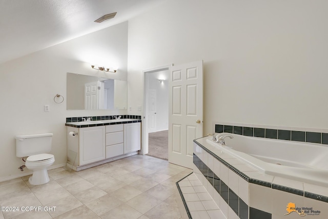 bathroom featuring toilet, tile patterned flooring, tiled tub, vanity, and high vaulted ceiling