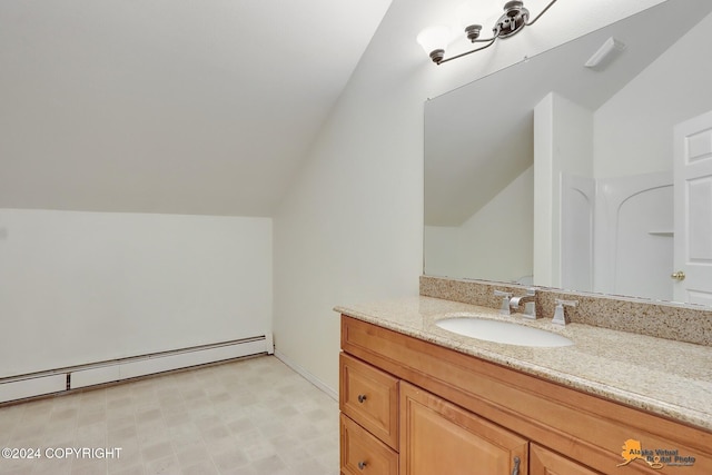 bathroom with vanity, lofted ceiling, and a baseboard heating unit