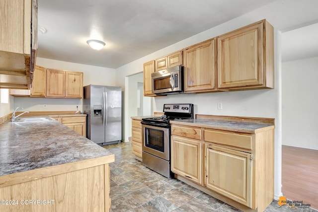 kitchen featuring sink, appliances with stainless steel finishes, and light brown cabinets