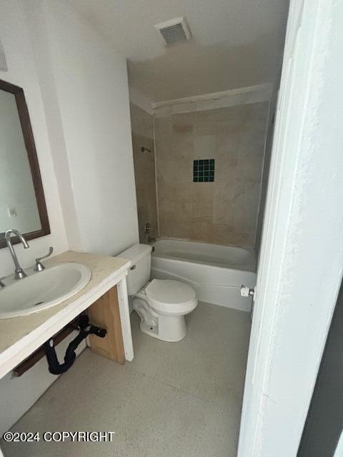 full bathroom featuring vanity, toilet, and tiled shower / bath