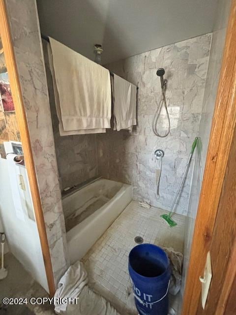 bathroom with a shower and tile patterned flooring