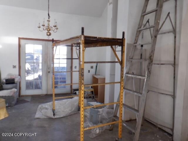 interior space with a notable chandelier and concrete flooring