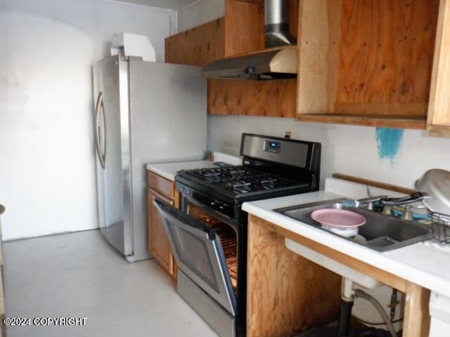 kitchen featuring wall chimney exhaust hood and appliances with stainless steel finishes