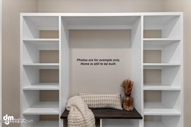 mudroom featuring built in shelves