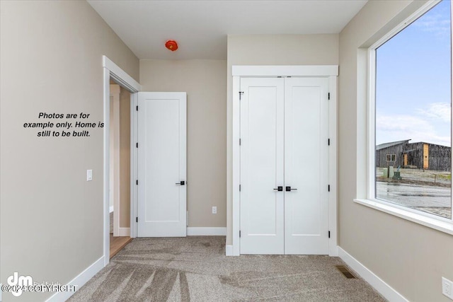 unfurnished bedroom with carpet floors and a closet