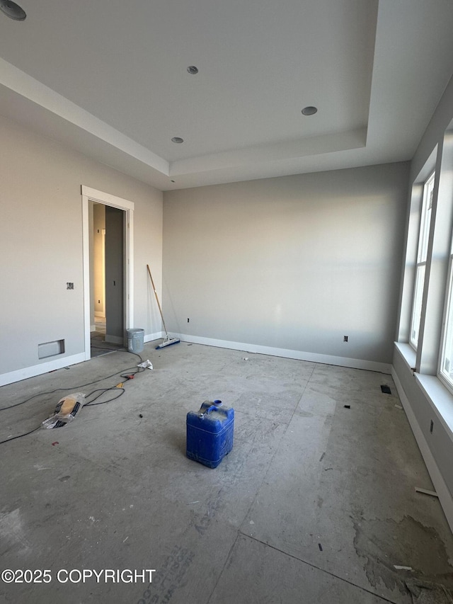 empty room featuring a tray ceiling